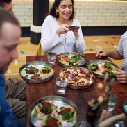 Girl taking a picture of her food at Mackie Mayor