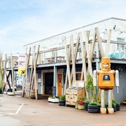 Robot sculpture outside a building with geometric décor