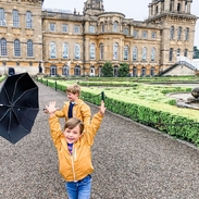 Two boys playing on a path in front of a palace