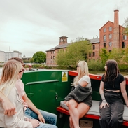 A group of people riding in a riverboat