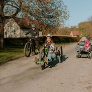 Jennie Berry using a hand bike at Dalby Forest with staff from the cycle hub.