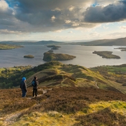 Walkers taking in the view of Loch Lomond from Conic Hill part of the West Highland Way