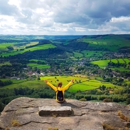 A woman with her arms raised enjoying the view from high