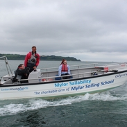 A man, with young boy and girl, on a sailing boat