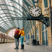 Man and woman gaze up at the ceiling at a train station